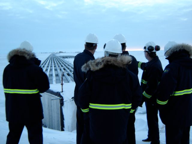 Mechanical Engineers Looking at Pipe